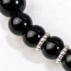 Shadow guardian obsidian bracelet close-up showing polished black beads and silver spacer details for a refined jewelry finish.