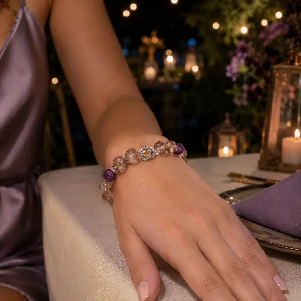 Hand wearing a beaded bracelet with a blurred outdoor setting