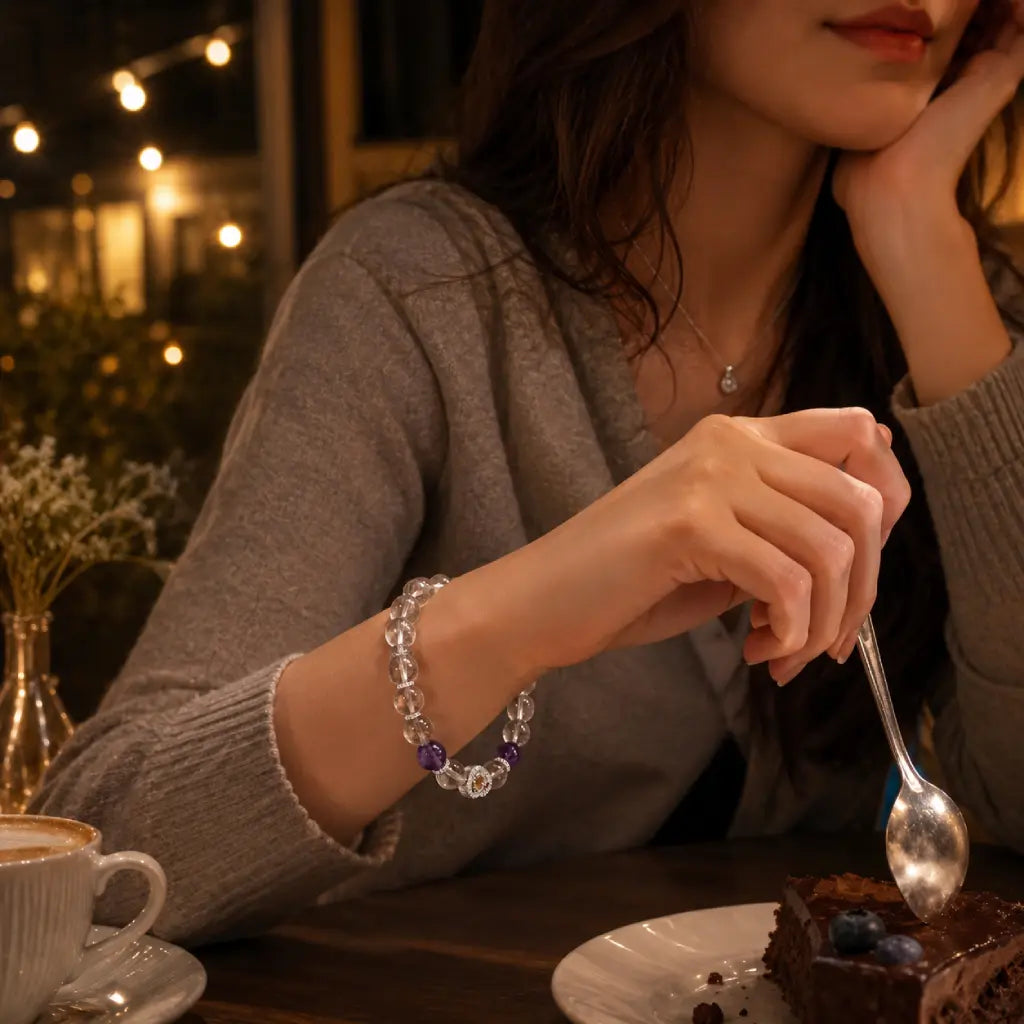 Woman enjoying dessert with a spoon at a cozy outdoor setting