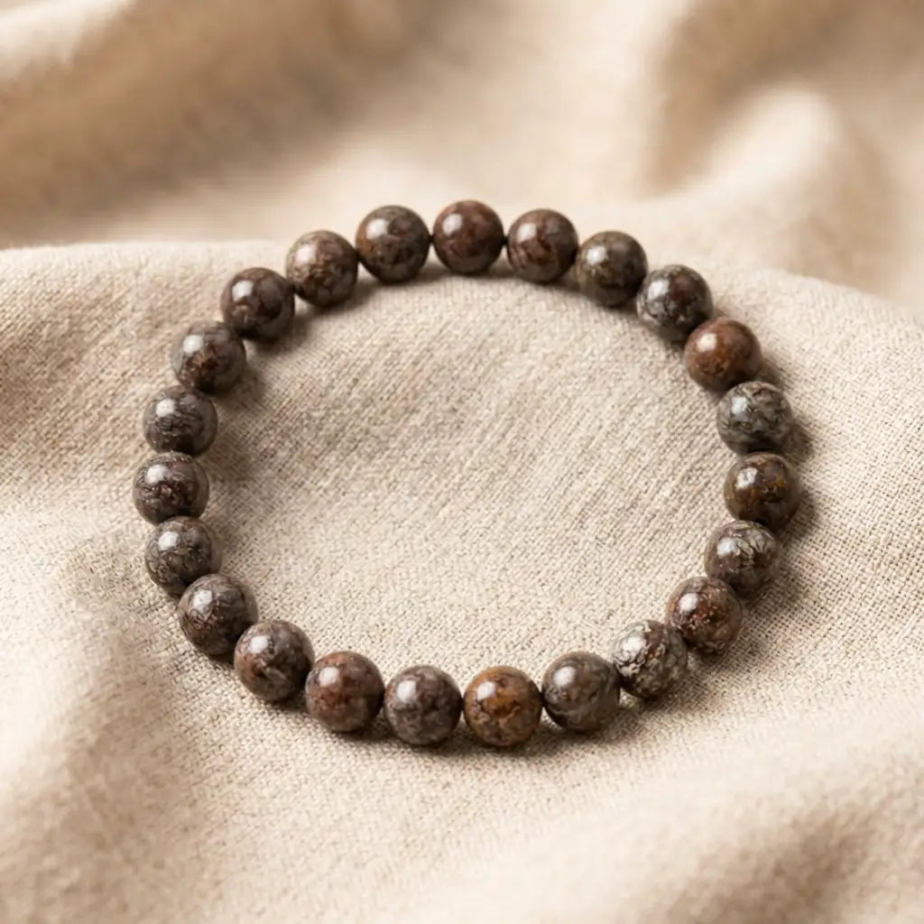 Snoflake bracelet glossy brown speckled beads on beige linen, earthy crystal jewelry for grounded everyday style