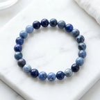 Sodalite stone bracelet polished blue bead bracelet on marble tile, natural gemstone jewelry for serene daily wear