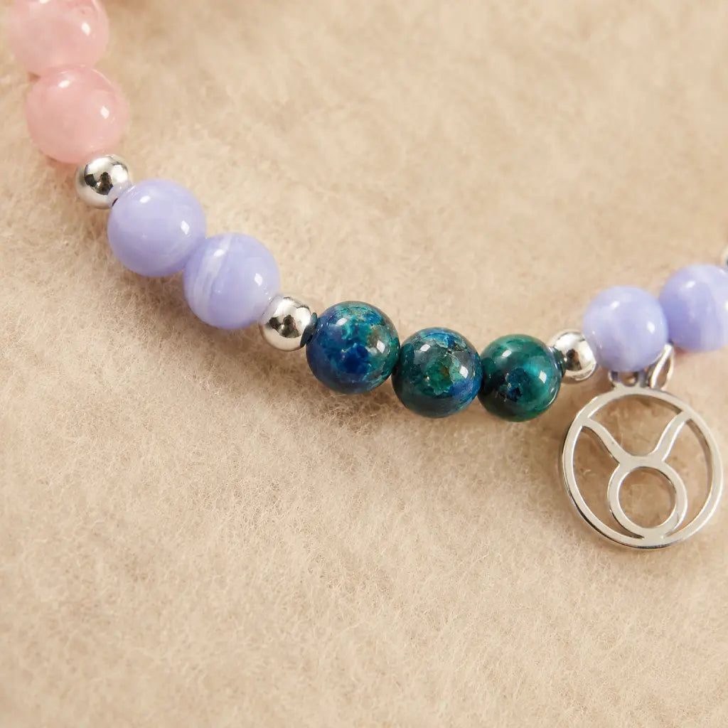 Taurus crystal bracelet featuring polished gemstone beads and a zodiac charm for spiritual jewelry enthusiasts