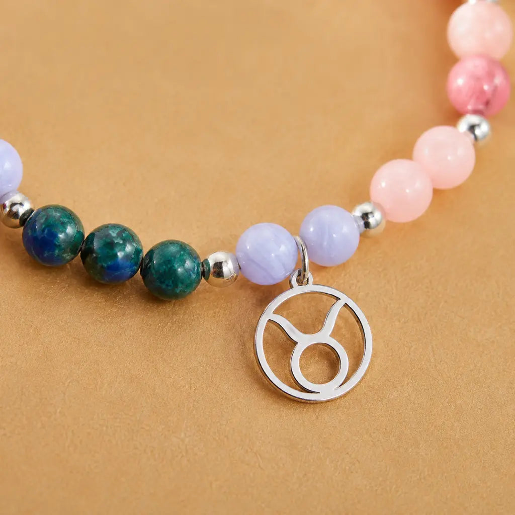 Taurus crystal bracelet displaying colorful gemstone beads and silver Taurus charm for astrology jewelry collectors