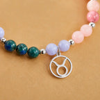 Taurus crystal bracelet displaying colorful gemstone beads and silver Taurus charm for astrology jewelry collectors