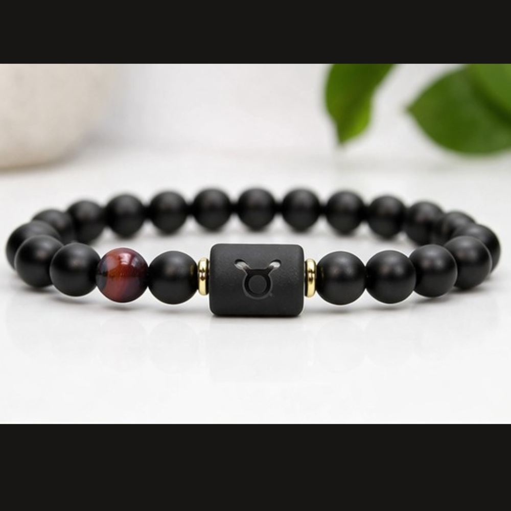 Taurus Zodiac Bracelet on white surface with black beads and tiger eye stone, modern astrology jewelry for balance calm energy and minimalist style