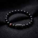 Taurus Zodiac Bracelet displayed on black fabric with matte beads and red tiger eye, elegant astrology jewelry for calm focus and balance