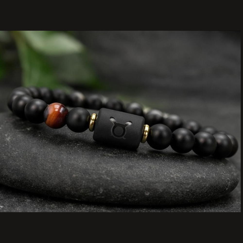 Taurus Zodiac Bracelet on stacked black stones with matte beads and tiger eye, elegant astrology jewelry for grounding energy strength and balance