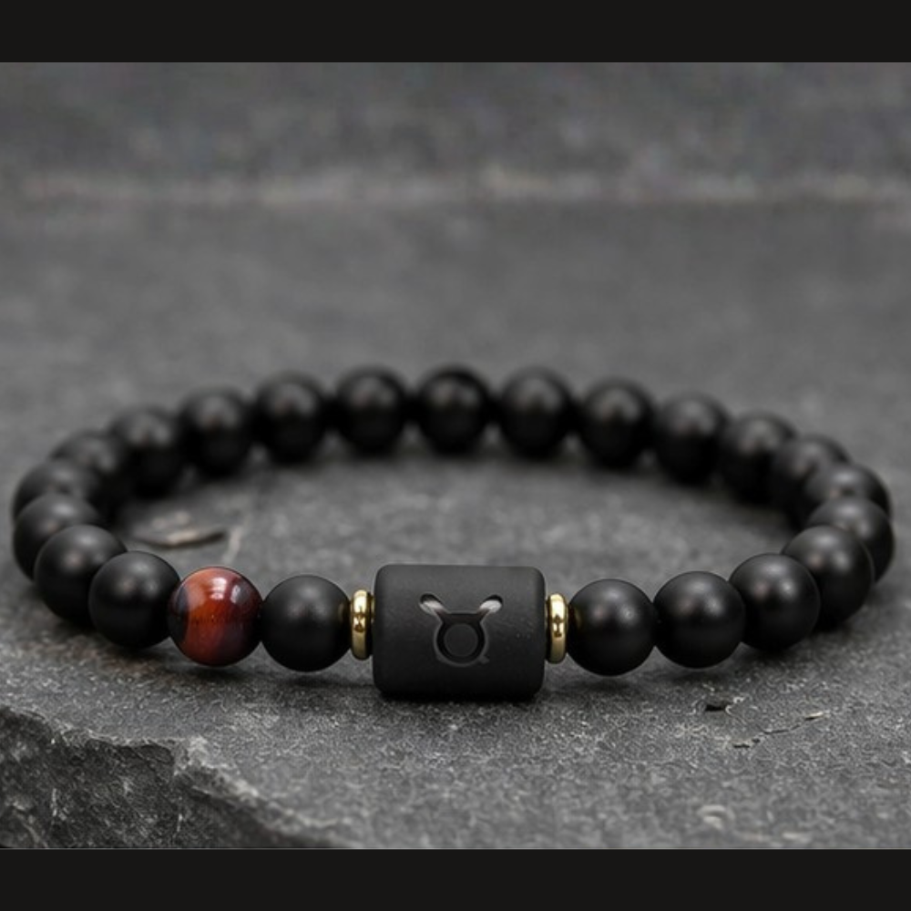 Taurus Zodiac Bracelet on dark stone with matte black beads and tiger eye accent, luxury astrology jewelry for strength stability and grounding energy