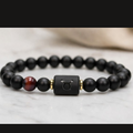 Taurus Zodiac Bracelet on marble surface with black matte beads and tiger eye, minimalist astrology jewelry for calm balance energy and style