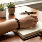 Taurus Zodiac Bracelet worn while writing at desk with black beads and tiger eye, modern astrology jewelry for productivity focus and grounded energy