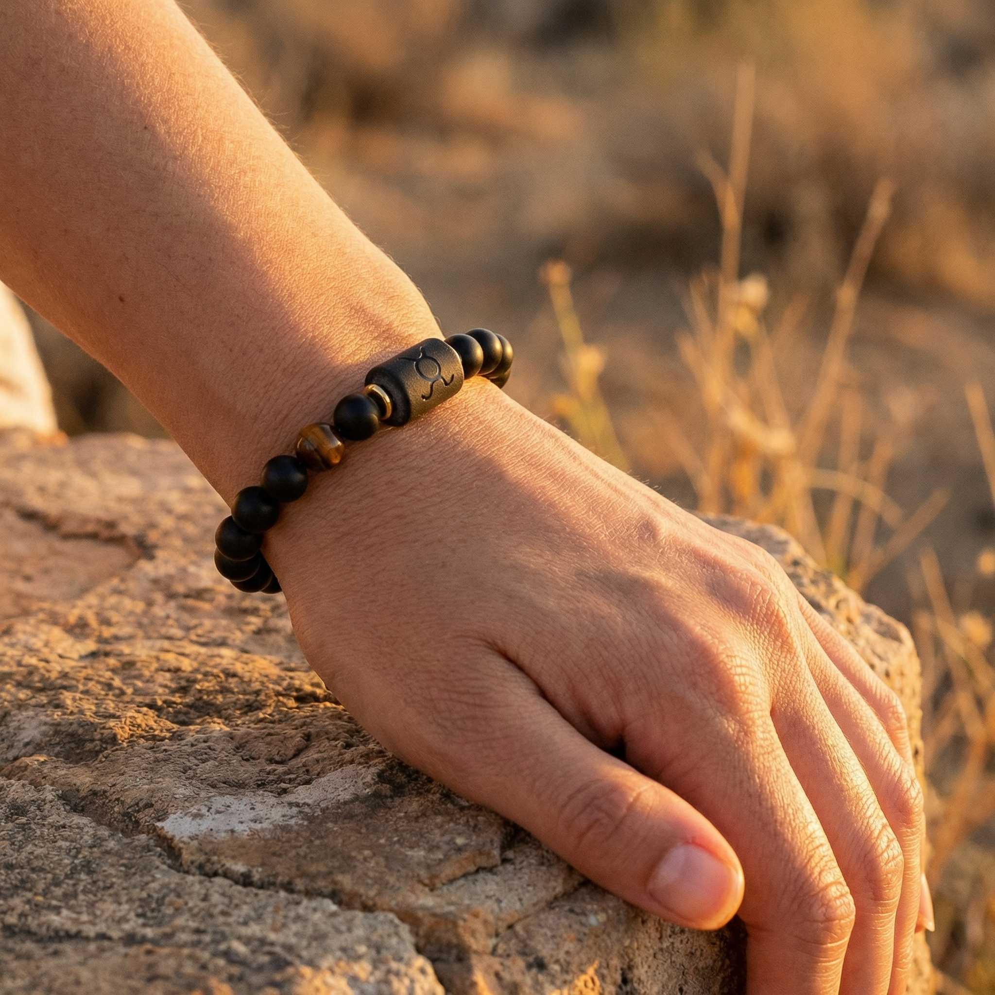 Taurus Zodiac Bracelet worn outdoors in sunlight with black beads and tiger eye, natural astrology jewelry symbolizing strength balance and calm energy