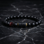 Taurus Zodiac Bracelet on dark marble surface with black beads and tiger eye accent, bold astrology jewelry for grounding energy and style