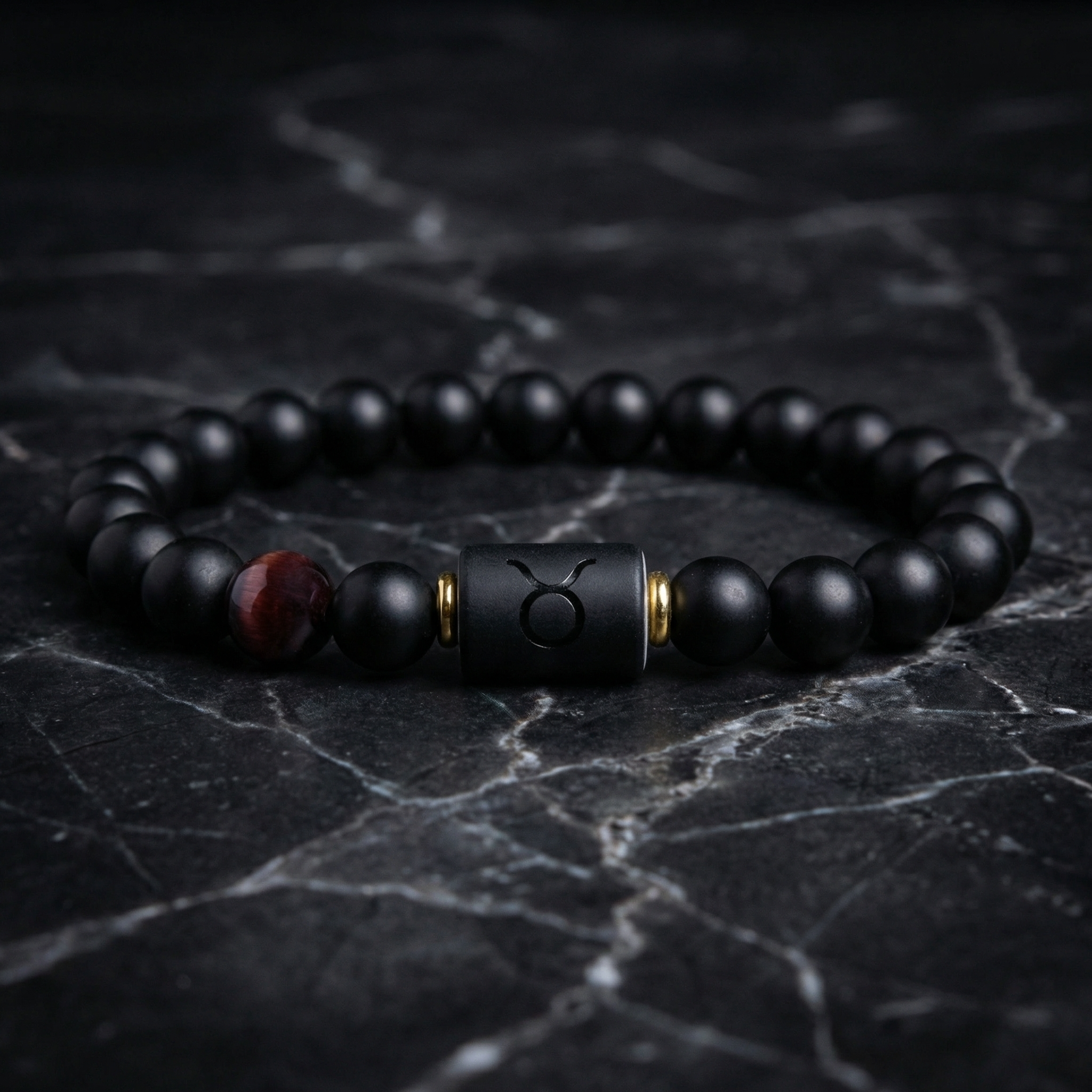Taurus Zodiac Bracelet on dark marble surface with black beads and tiger eye accent, bold astrology jewelry for grounding energy and style