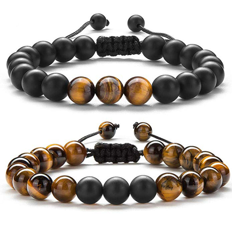 Tiger eye couple bracelets displayed as two coordinated strands with golden-brown tiger eye beads, matte black round beads, and adjustable black braided cords in one complete view.