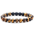 Tiger eye couple bracelets displayed in a round stretch-style strand with matte black beads and golden-brown tiger eye accents arranged around the center with sizing details shown.