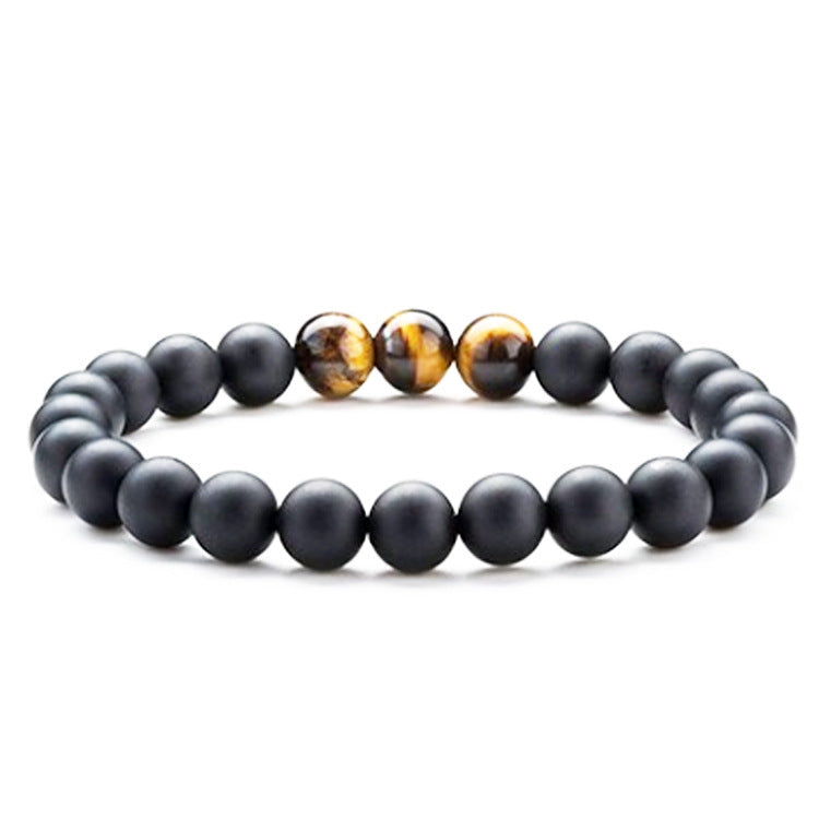Tiger eye couple bracelets shown in a polished round-bead strand with matte black beads and three golden-brown striped accents centered across the front for easy visual comparison.