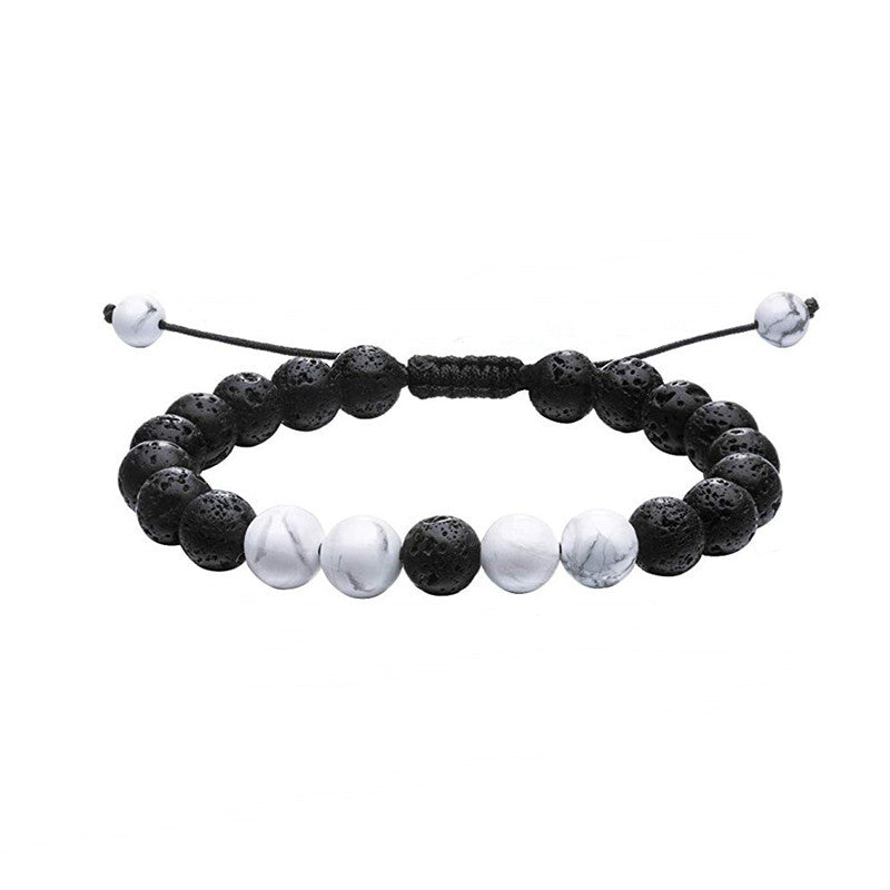 Tiger eye couple bracelets shown in a black and white coordinated strand with porous black beads, white marbled round accents, and adjustable braided cord in a balanced front view.