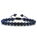 Tiger eye couple bracelets displayed in deep-blue and matte black round beads with two slim adjustable cord strands arranged together on a clean white background in one clear view.
