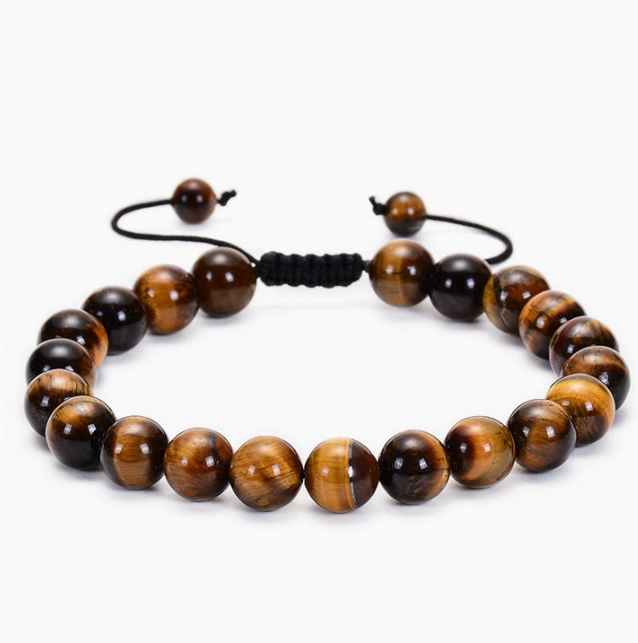 Tiger eye couple bracelets style shown as one adjustable strand of polished golden-brown striped round beads with a black woven sliding knot and cord ends in a balanced front view.