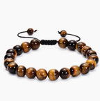 Tiger eye couple bracelets style shown as one adjustable strand of polished golden-brown striped round beads with a black woven sliding knot and cord ends in a balanced front view.