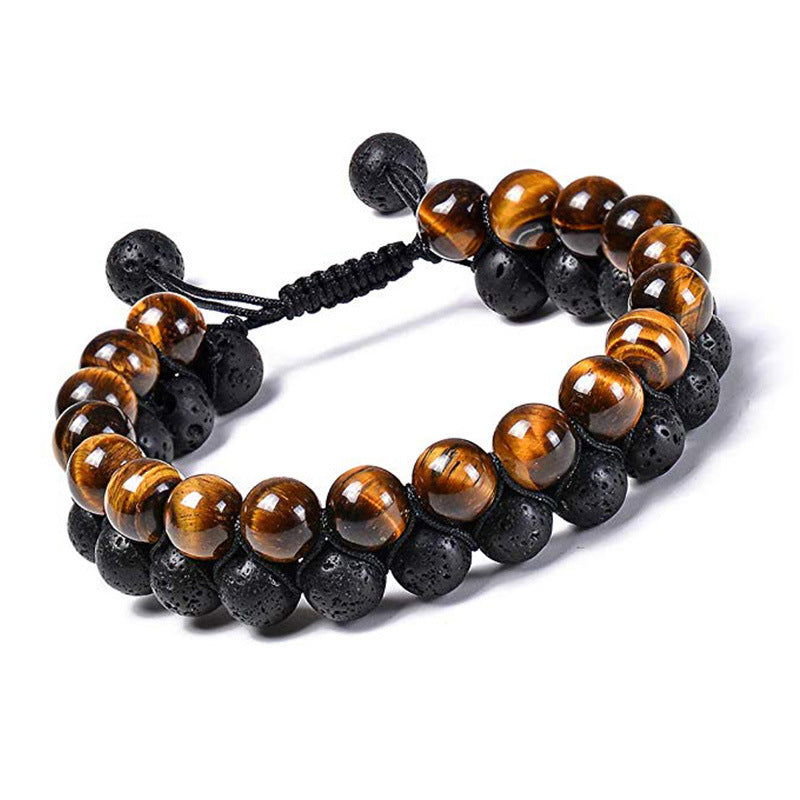 Tiger eye couple bracelets displayed as two linked rows of polished golden-brown beads and porous black beads with a woven black adjustable closure with the color contrast visible.