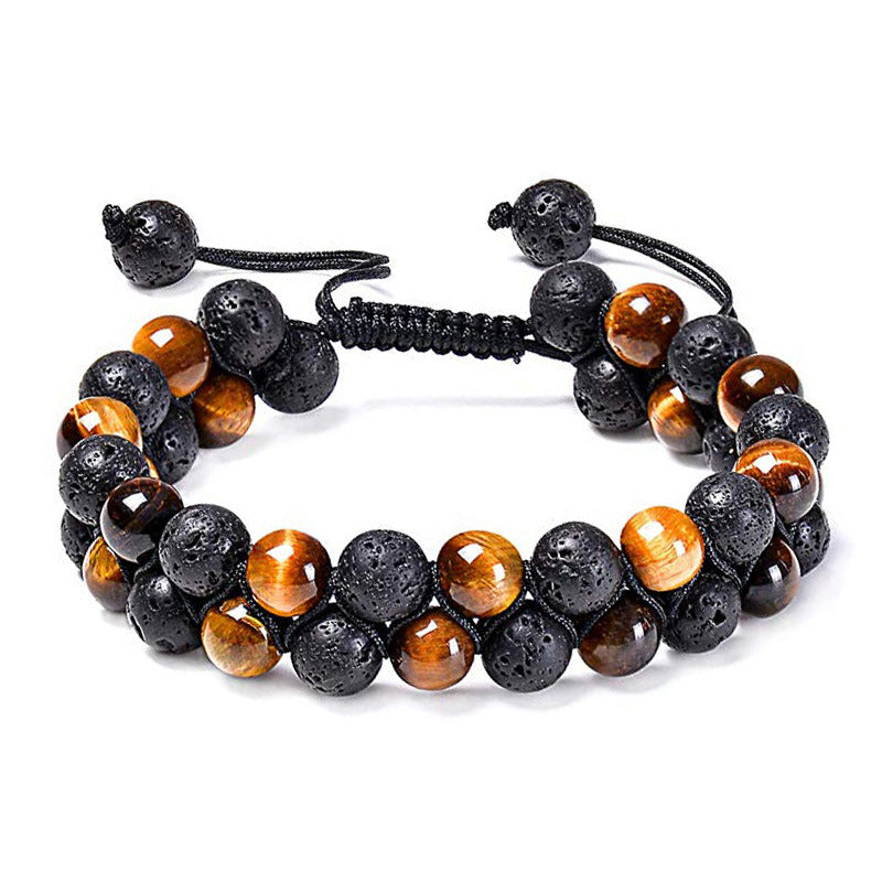 Tiger eye couple bracelets shown as a bold double strand with porous black beads, golden-brown striped round beads, and black adjustable braided cord ends in a balanced front view.