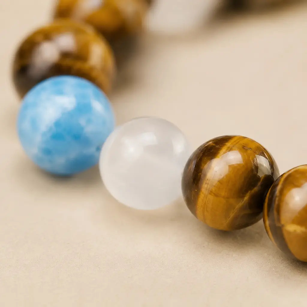 Tiger eye bracelet closeup featuring polished blue and white gemstone beads with crystal jewelry texture detail