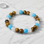 Tiger eye bracelet presented on marble surface with natural crystal jewelry for modern premium style