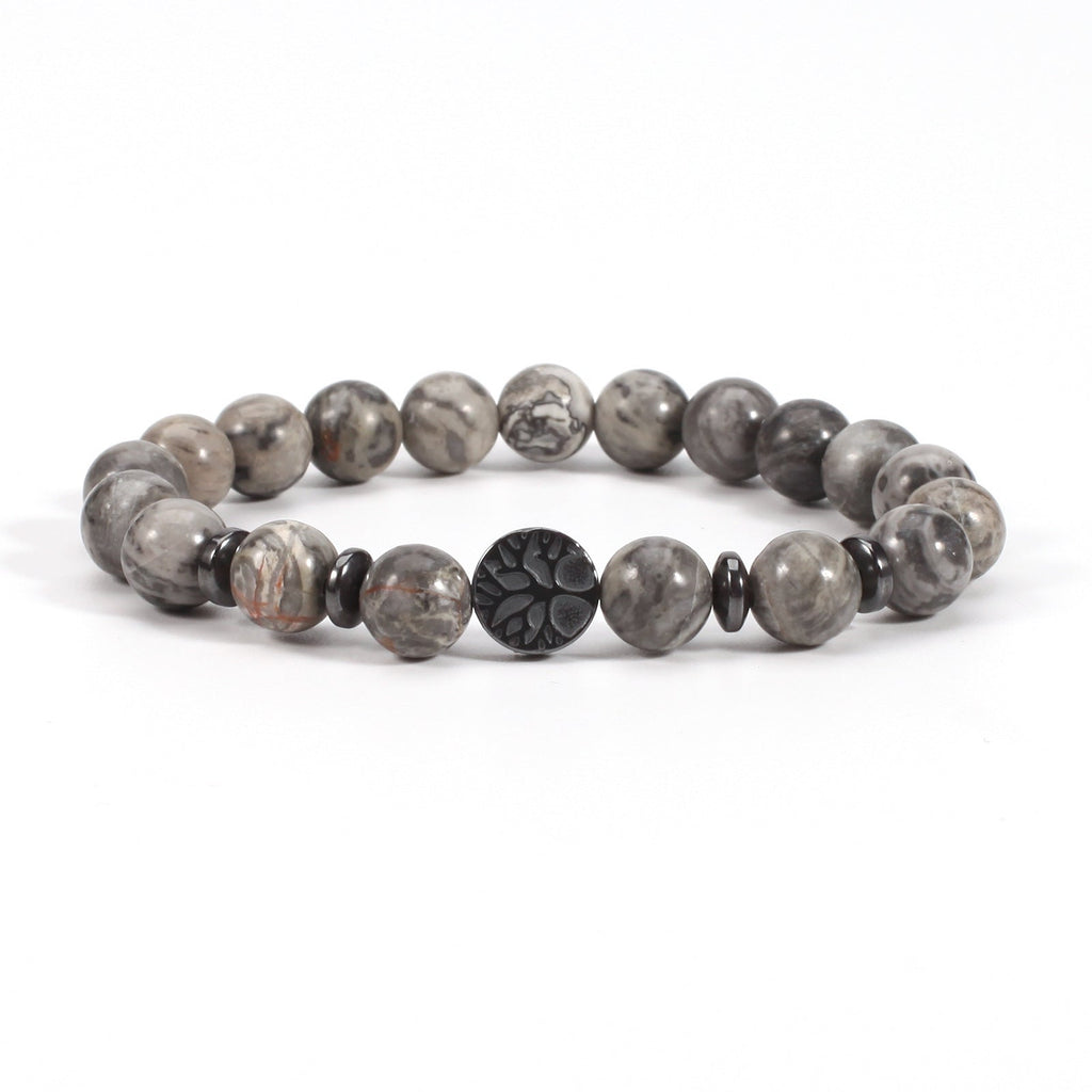 Tree of life stone bracelet in the Map Stone option, featuring glossy gray marbled 8mm beads, black spacer rings, and a round dark tree-design focal bead on white for a clear view.