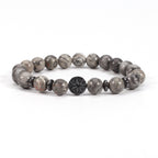 Tree of life stone bracelet in the Map Stone option, featuring glossy gray marbled 8mm beads, black spacer rings, and a round dark tree-design focal bead on white for a clear view.