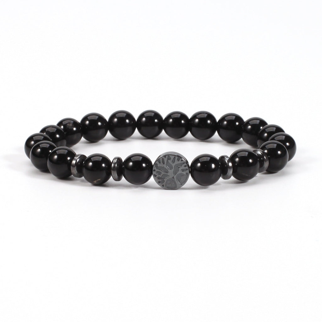 Tree of life stone bracelet in the Obsidian option, with glossy black 8mm round beads, black spacer rings, and a round dark tree-design focal bead on white in a clean product view.