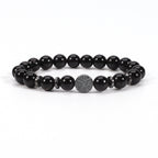 Tree of life stone bracelet in the Obsidian option, with glossy black 8mm round beads, black spacer rings, and a round dark tree-design focal bead on white in a clean product view.
