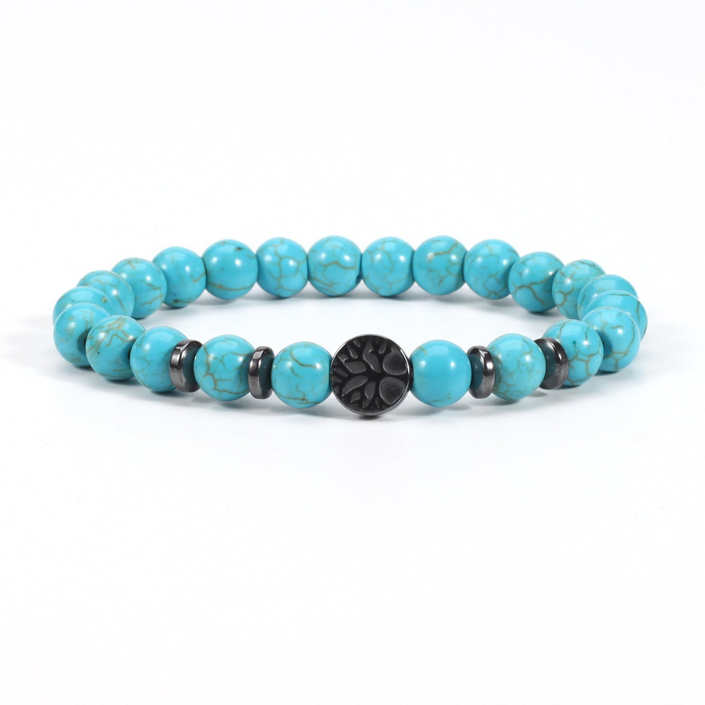 Tree of life stone bracelet in the Synthetic Turquoise option, showing bright blue 8mm beads, black spacer rings, and a round dark tree-design focal bead on white for a clear view.