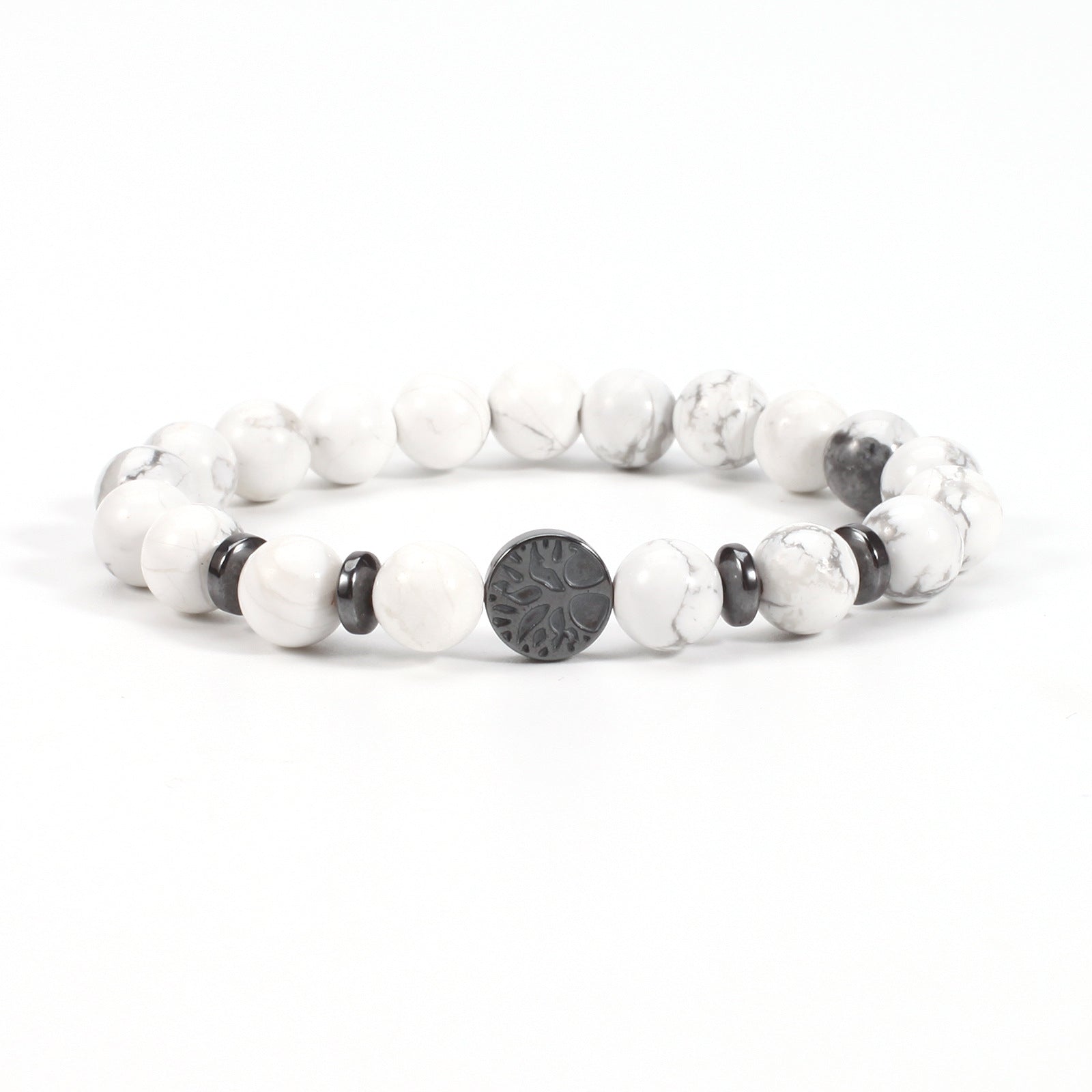 Tree of life stone bracelet in the White Turquoise option, showing white and gray-veined 8mm beads, black spacer rings, and a round dark tree-design focal bead on a white backdrop.
