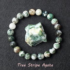 Tree Stripe Agate bracelet with mossy green and white beads, believed to represent grounding and natural abundance