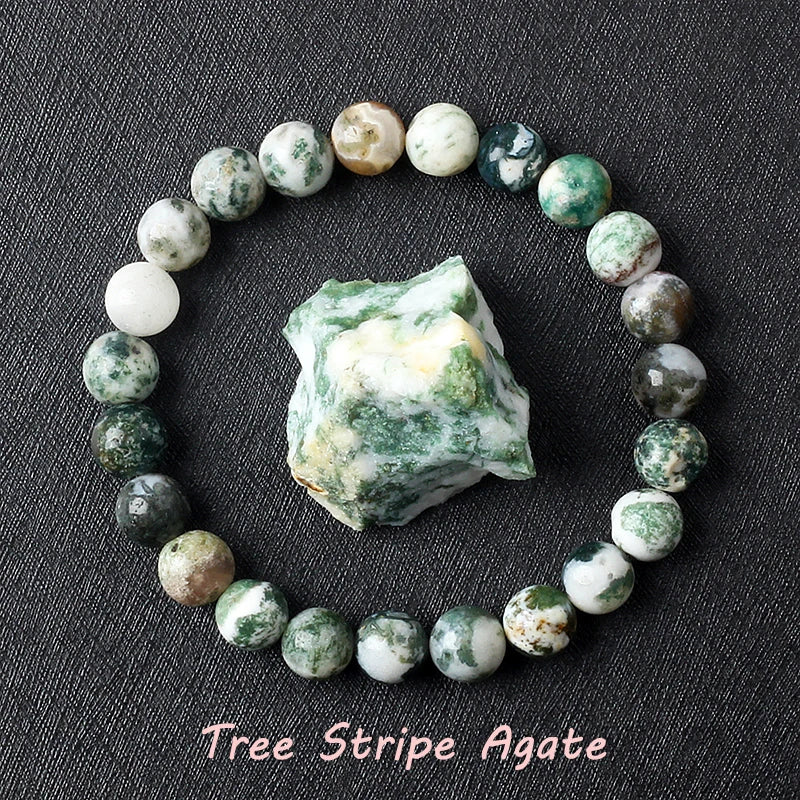 Tree Stripe Agate bracelet with mossy green and white beads, believed to represent grounding and natural abundance