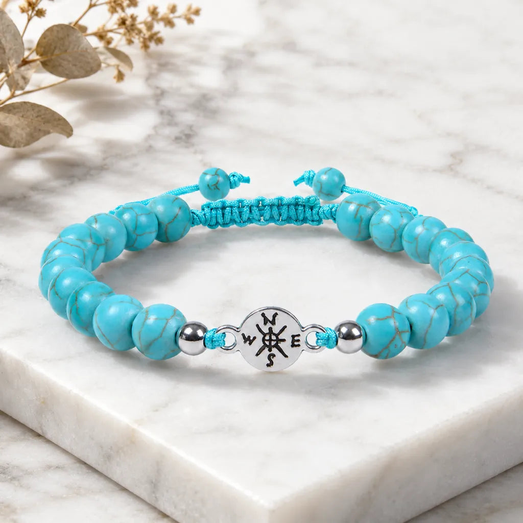 Turquoise bracelet styled on marble surface with bright blue beads for premium spiritual fashion wear