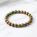 Unakrite stone bracelet glossy green orange bead bracelet on white marble, earthy gemstone jewelry daily wear look