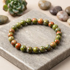 Unakrite stone bracelet green pink bead stretch bracelet on stone slab, earthy gemstone jewelry for balanced style