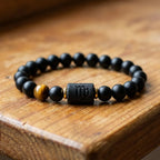 Virgo zodiac bracelet on rustic wood with black beads and tiger eye stone for earthy grounded style and gifting appeal