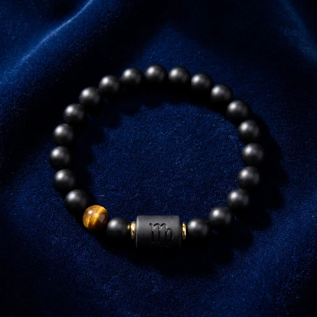 Virgo zodiac bracelet on deep blue fabric with black beads and tiger eye detail for elegant refined astrology jewelry style