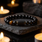 Virgo zodiac bracelet with black beads and tiger eye stone on candlelit background for calming spiritual gift appeal