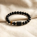 Virgo zodiac bracelet on soft beige fabric with black beads and tiger eye stone for calm minimalist aesthetic gift appeal