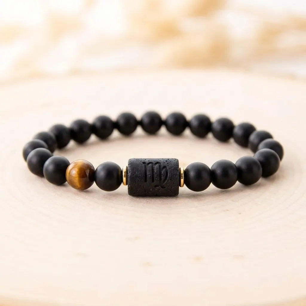 Virgo zodiac bracelet on beige background with black beads and tiger eye accent for modern minimalist jewelry styling