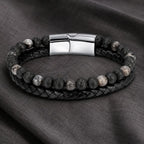 Volcanic Rock Larvikite bracelet on fabric surface with braided leather and natural stone beads for style
