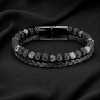Volcanic Rock Larvikite bracelet on dark fabric background with braided leather and lava beads for bold appeal