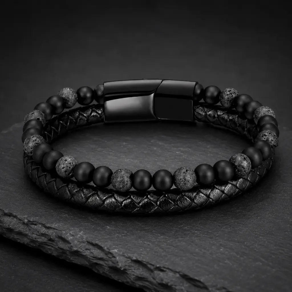 Volcanic Rock bracelet with braided leather and black lava beads on slate display for luxury appeal