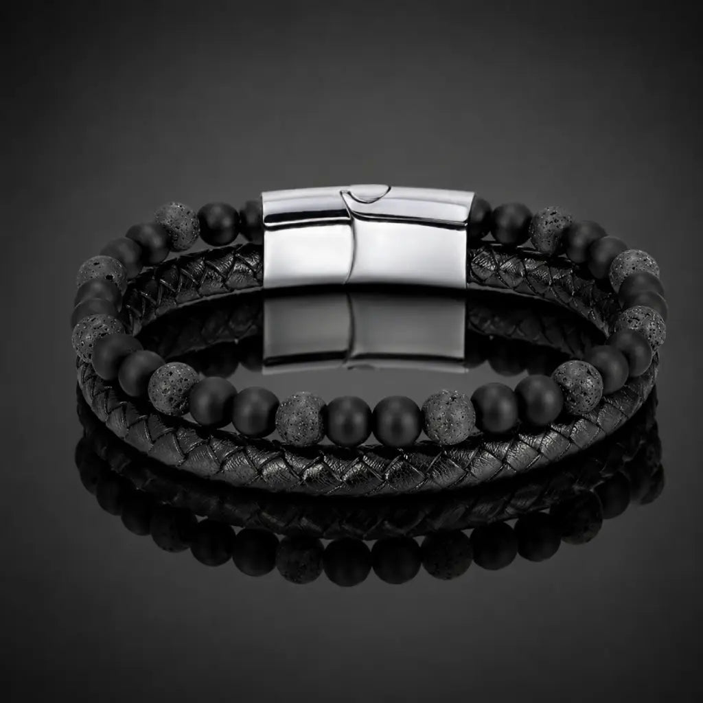 Volcanic Rock bracelet with braided leather and lava stone beads on reflective black display for modern style