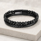 Volcanic Rock bracelet with lava beads and braided leather on stone platform for premium appearance