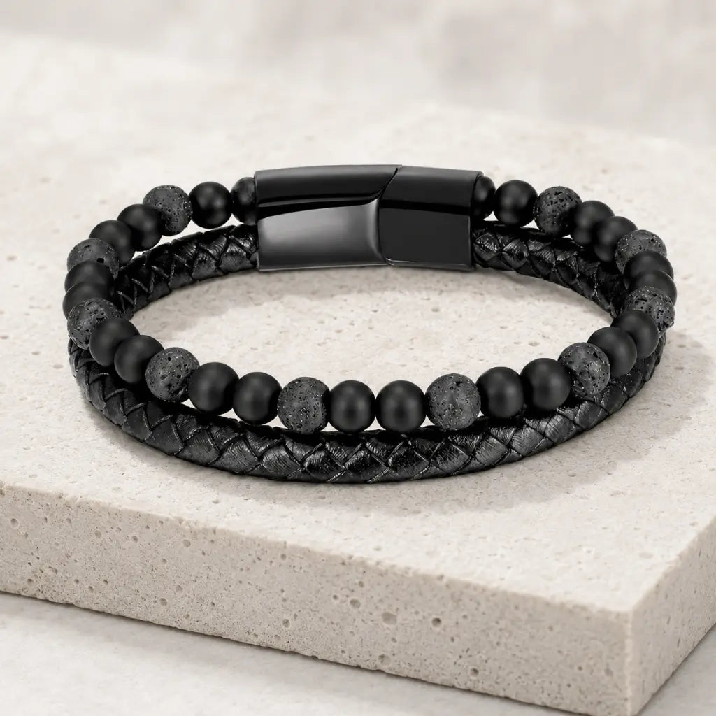 Volcanic Rock bracelet with lava beads and braided leather on stone platform for premium appearance